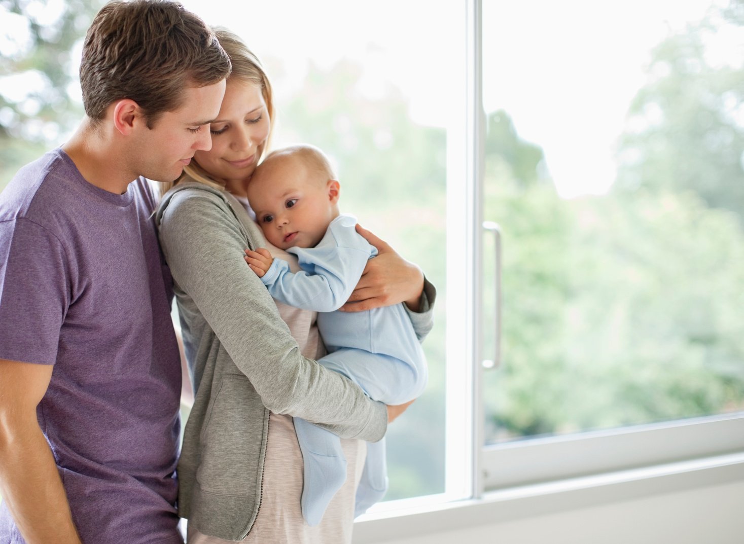 Father and mother embracing t heir baby boy (6-11 months)