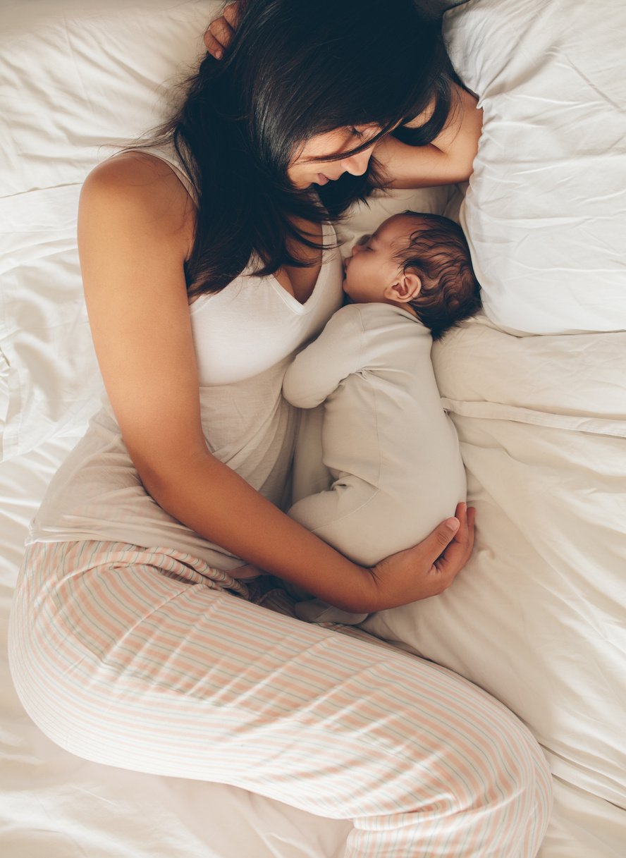 Mother and Son Sleeping on Bed